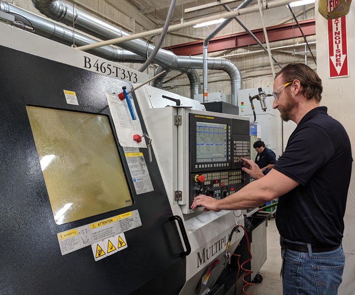 Fixed headstock team leader Ryan Beck using a FANUC control at a lathe